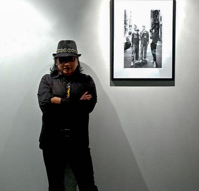 Sunny Bak, photographer standing next to her image of the Beastie Boys
